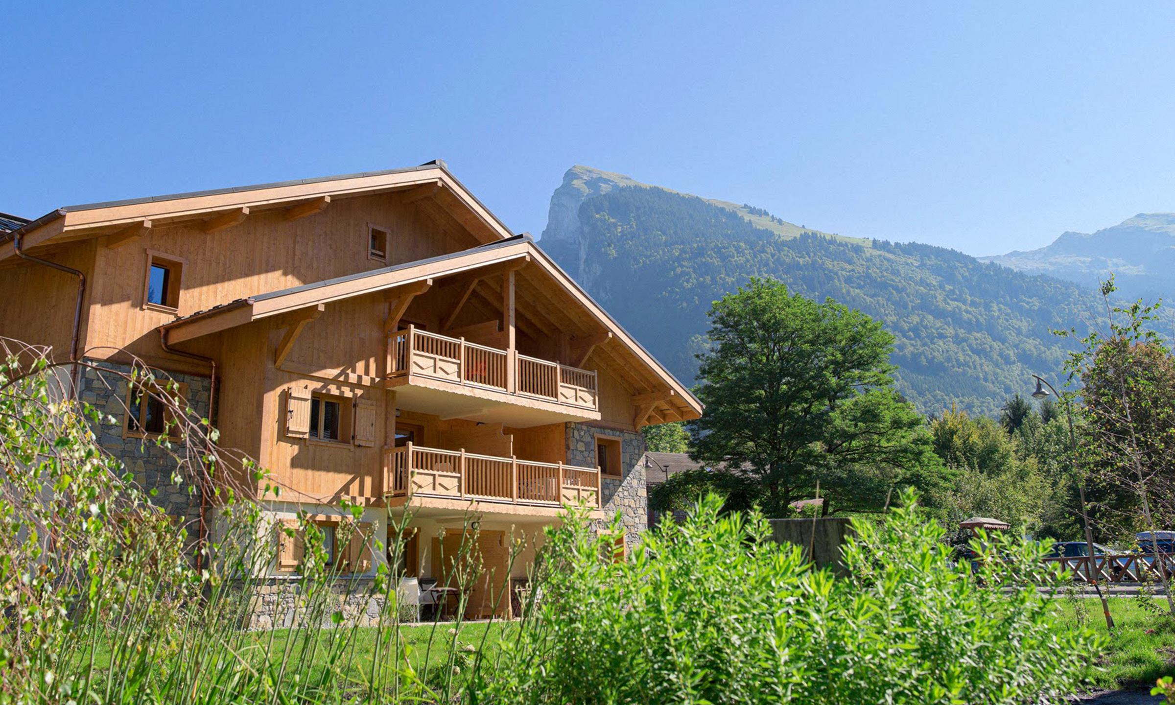 Extérieur en été de la résidence CGH La Reine des Prés à Samoëns dans les Alpes